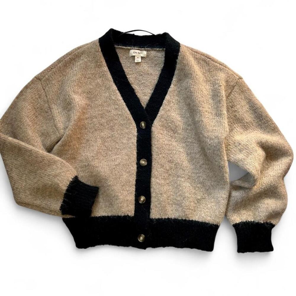 On 34th beige cardigan with black trim, super soft